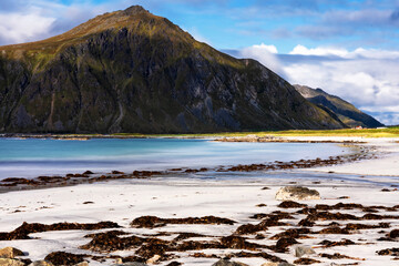 White sands washed by crystal turquoise water. Seascape views from Ramberg beach at Lofoten Islands, Norway