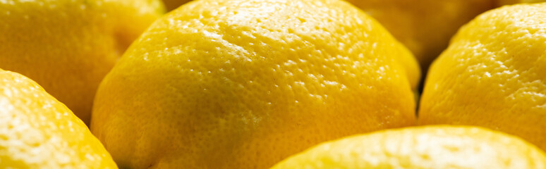 close up view of ripe yellow fresh lemons, panoramic crop