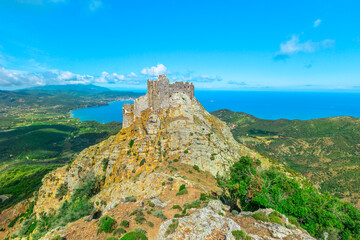 Fototapeta na wymiar Iconic view of Volterraio Castle on rock at 394 m. Fortress of Volterraio, symbol of Elba Island, dominates Portoferraio Gulf. The never conquered italian castle in all history.