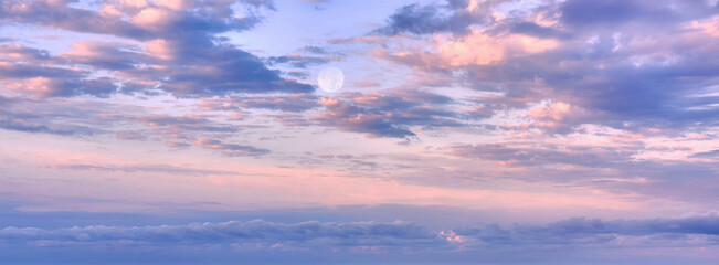 Dramatic sunset clouds and full Moon