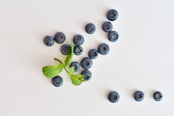 Fresh blueberries with mint leaves isolated on white background. Top vew