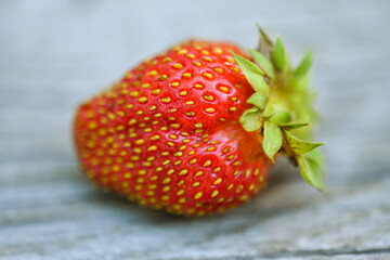 Closeup on fresh and recently picked strawberry placed on wooden board