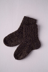 Black handmade warm knitted wool socks pair for cold winter, isolated
