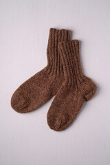 Brown handmade warm knitted wool socks pair for cold winter, isolated
