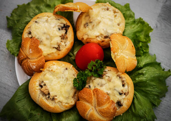 Buns and julienne baked buns with julienne in the middle, all on lettuce leaves