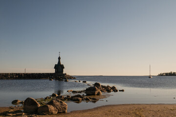 The church standing on the beach on blue sky.
