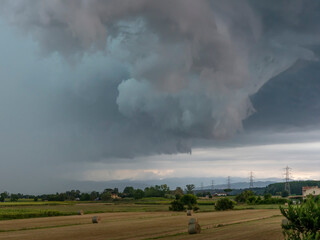 Fototapeta na wymiar A very picturesque and dramatic sky over the Tuscan countryside during a summer storm, Bientina, Pisa, Italy