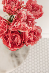 Closeup of beautiful pink peony tulip flowers bouquet in on mosaic tile