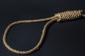 Loop from a rope on a black background. Social problem. The end of the path