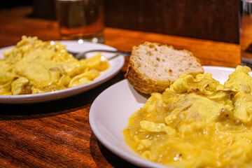 Potato and egg scrambled as a pintxo in a bar of the old town in San Sebastian. Basque Cuisine in a vegetarian pintxo. 