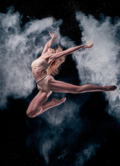 girl dancing in flour .background black.