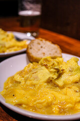 Potato and egg scrambled as a pintxo in a bar of the old town in San Sebastian. Basque Cuisine in a vegetarian pintxo. 
