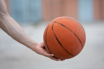 Basketball in the hands on the street