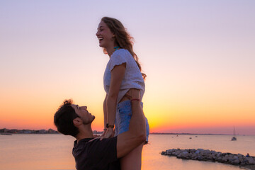 Fototapeta premium young couple of lovers having fun in the sunset light