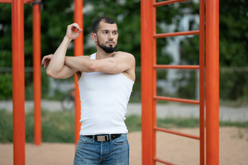 Man does a warm-up before training on the street. Workout, training, lifestyle