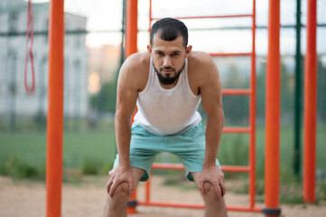 Obraz premium Man was tired after training. The athlete regains his breath
