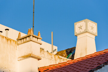 Fototapeta na wymiar chimney and tiled roof of a traditional house, in Tavira, Algarve, Portugal