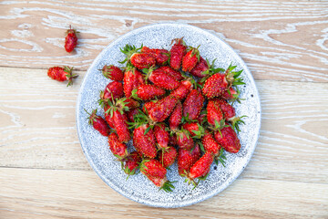 ripe strawberries on light wooden table