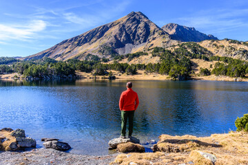 Hiker at the Lake of Camporells, Capcir, in the France Pyrenees Mountains.