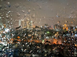 blur raindrops on the window , night city view