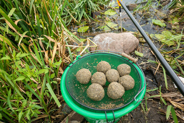 Groundbait balls ready for baiting fish. Fishing groundbait.  Kule zanętowe gotowe do nęcenia ryb. Zanęta wędkarska. © SebbPL