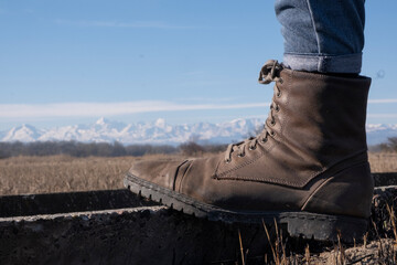 
boot in the foreground with mountains in the background