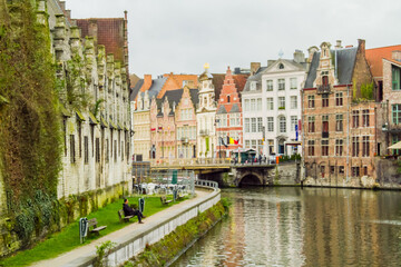 Fototapeta na wymiar Ghent, Belgium; Houses and apartments line a canal in Ghent
