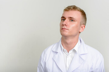 Portrait of young man doctor with blond hair