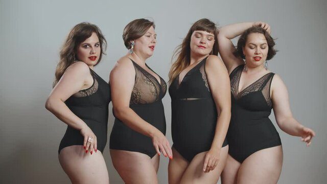 Portrait of beautiful plus size young women on black bodysuit dancing and posing at camera