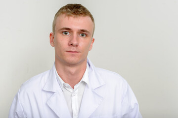 Portrait of young man doctor with blond hair