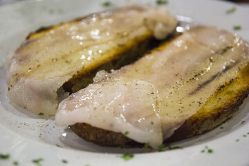 Italian toasted bread with pork lard and pepper. Traditional food - 366984055