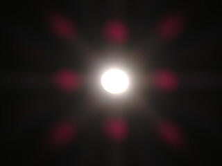 The moon shines in the night sky.