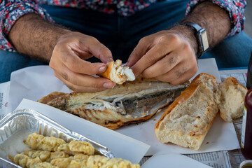 Close up man eating fish