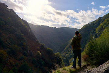 Fototapeta na wymiar Man looking at a valley in autumn