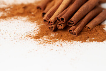 Background image macro cinnamon sticks on a white background