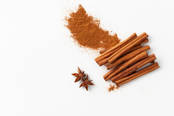 Cinnamon sticks on white background, place for text