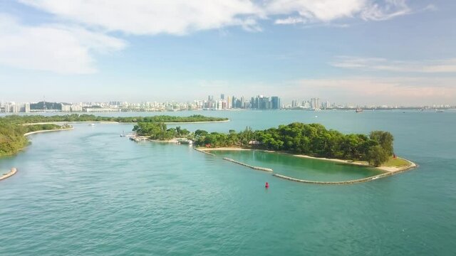 Aerial shot of tropical kusu island with city skyline, Singapore