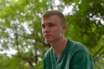 Portrait of young man with blond hair outdoors