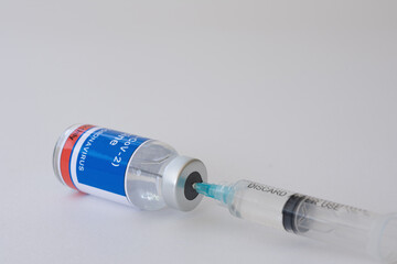 Close-up vaccine vials and syringe for prevention, immunization, and treatment from Coronavirus (COVID-19) or SARS-CoV-2. Pandemic COVID-19 virus and protection against the Coronavirus concept.