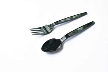 black  plastic spoon and fork for single used on white background