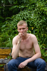 Portrait of young man with blond hair shirtless outdoors