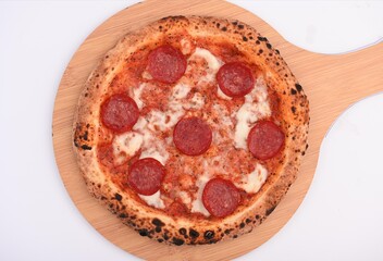 A delicious pizza dish with a little bit of pepperoni and tomato sauce