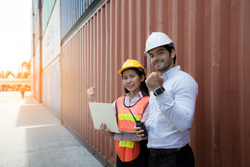 Handsome young engineers using walkie-talkie for communication to control the transportation of products through containers on the job site. Professional supervisor for new business and big projects.