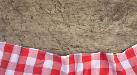Background with red and white checkered napkin on rustic non paint wooden planks. Space for text