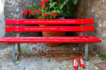red bench with shoes symbol against violence against women cervo italy     I translate written in...