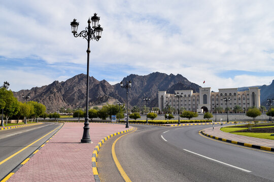 Picture of State Audit Institution building with the mountains behind, taken from an empty road in Muscat.