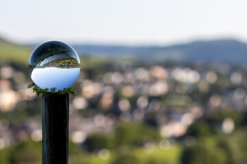Crystal ball with landscape and defocused background