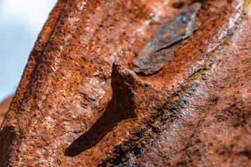 close up of an old rusty metal anchor with a spike