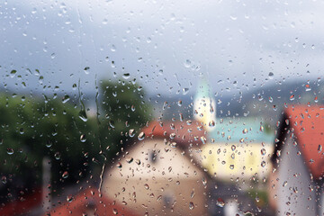 Rain drops on window glass , rainy day in my hometown