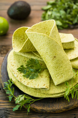 Green spinach tortilla on the wooden table